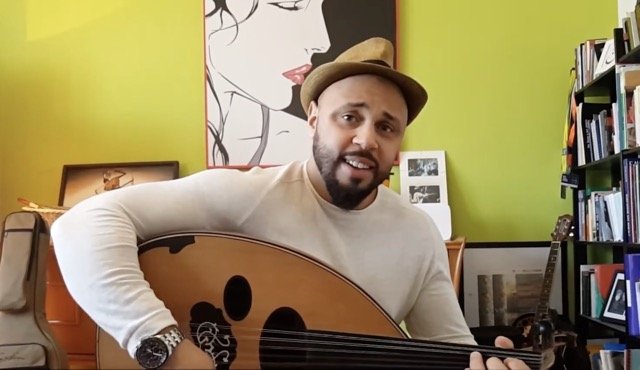 Marwan Samer playing oud in his home or studio
